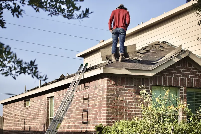 Professional roofer working on a residential roof in Brandermill